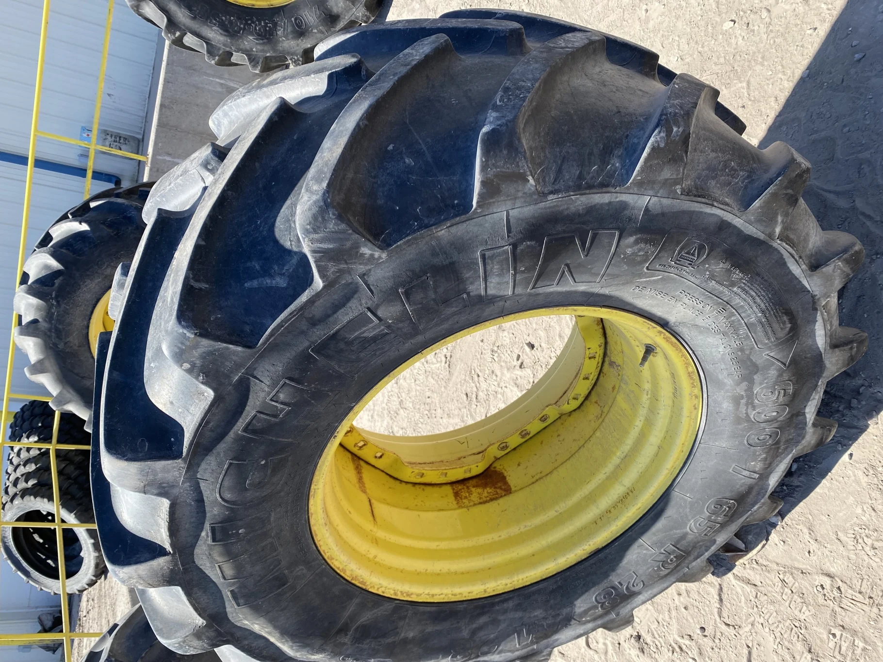 Used 600/65R28 Michelin XM28 TL 67% on a 18 x 28 JD Yellow Waffle Wheel (3 Bolt) 4" offset   (