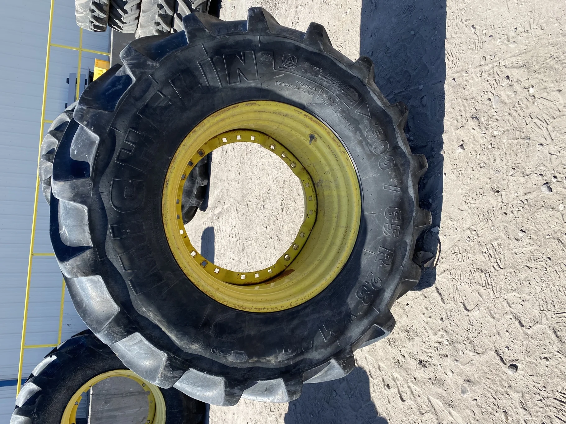 Used 600/65R28 Michelin XM28 TL 67% on a 18 x 28 JD Yellow Waffle Wheel (3 Bolt) 4" offset   ( image 2