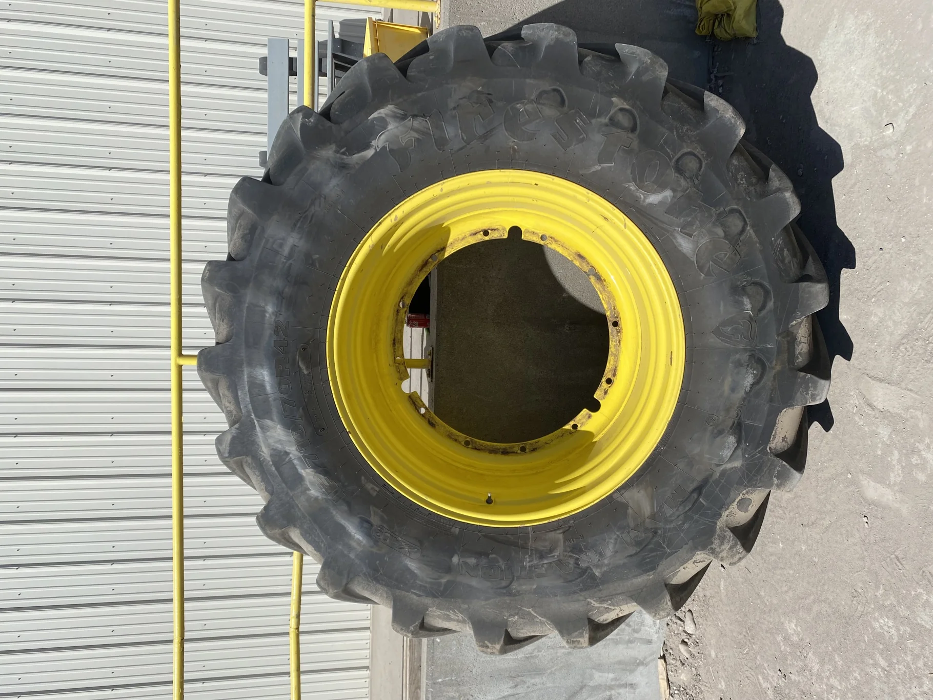 Used 93% IF710/70R42 Firestone Maxi Traction R-1W (179D) TL on a 23 x 42 JD Yellow 12-32.04-30.07