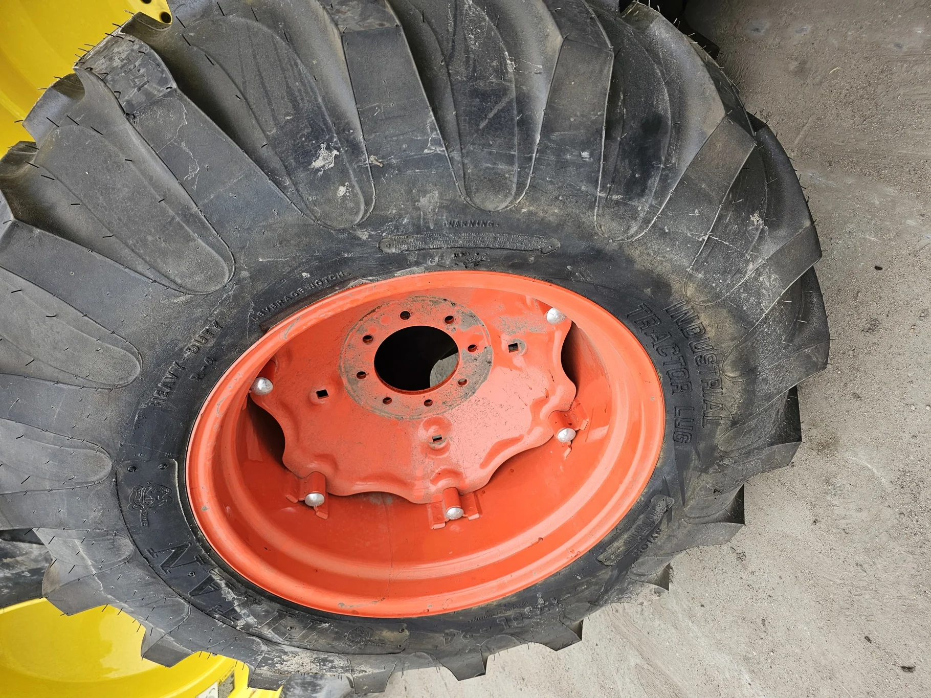 Take-Off 17.5L-24 Titan Industrial Tractor Lug R-4 8Ply TL on a 15 X 24 Kubota Orange 6 Loop Wheel
