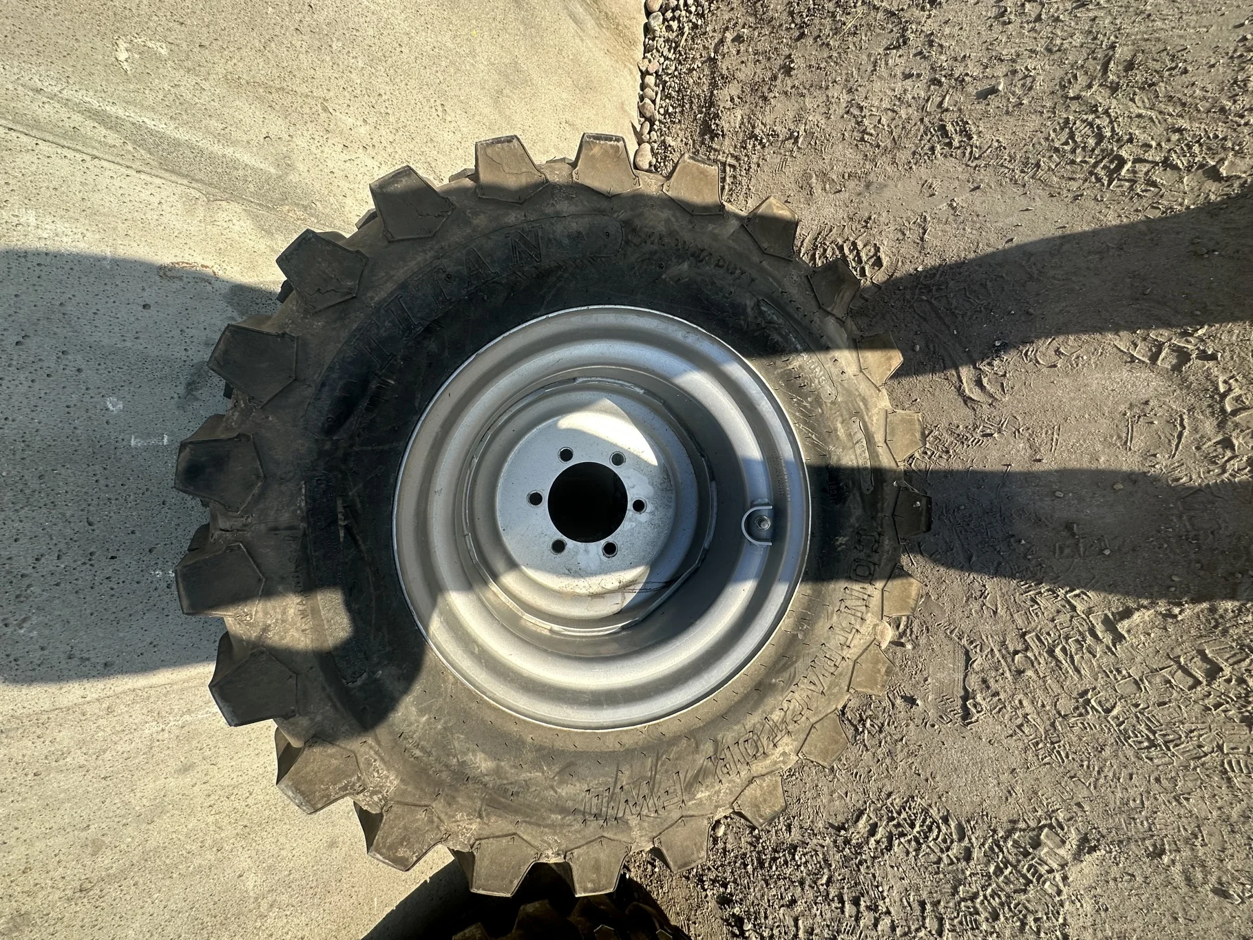 USED 12-16.5 Titan Trac Loader NHS C(6Ply) TL 95% on a 9.75 X 16.5 Silver Mist 6 Bolt Imp Wheel image 2