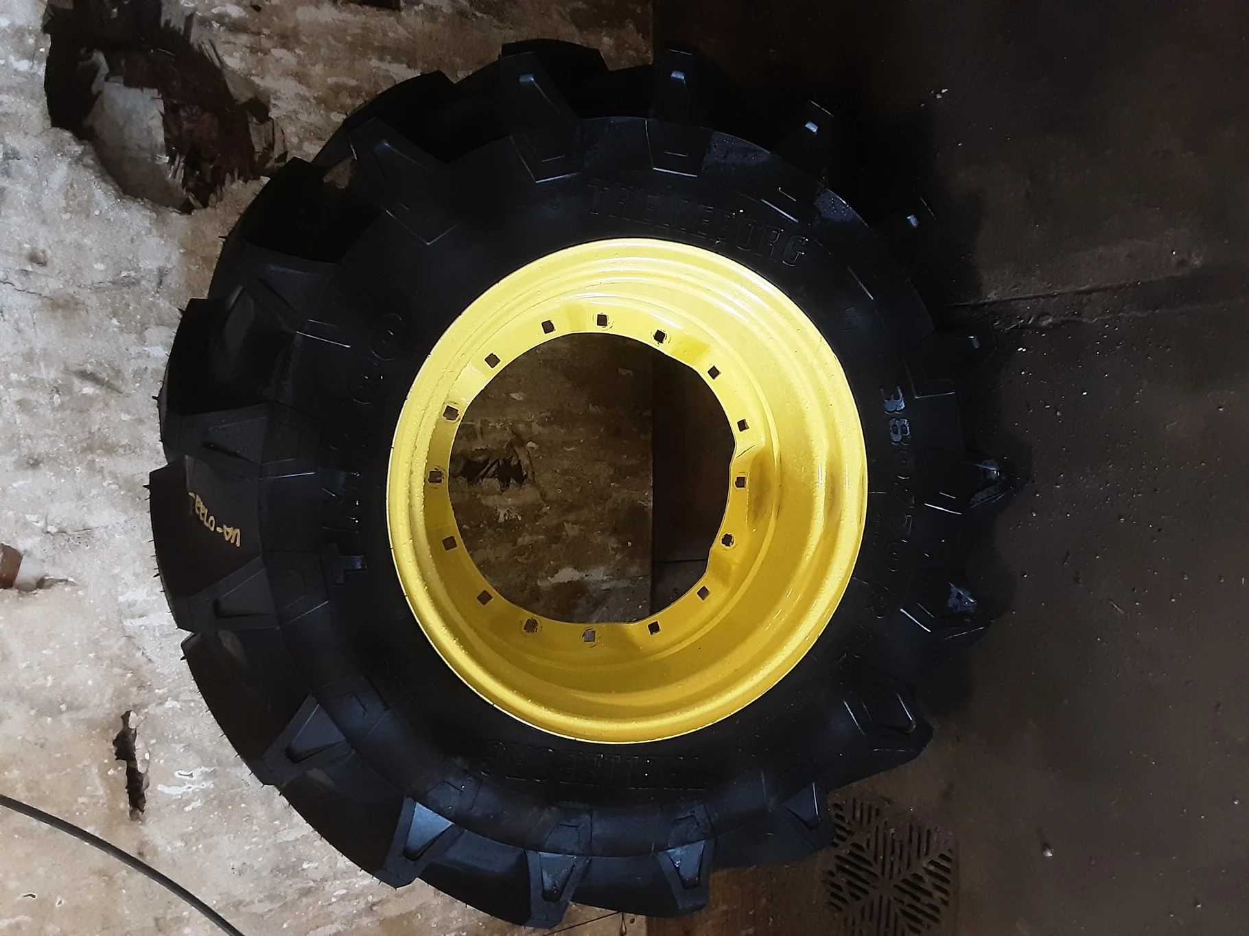 Take-Off 380/70R24 125A8 Trelleborg TM700 R-1W TL on a 12 X 24 2 Bolt JD Yellow Waffle Wheel