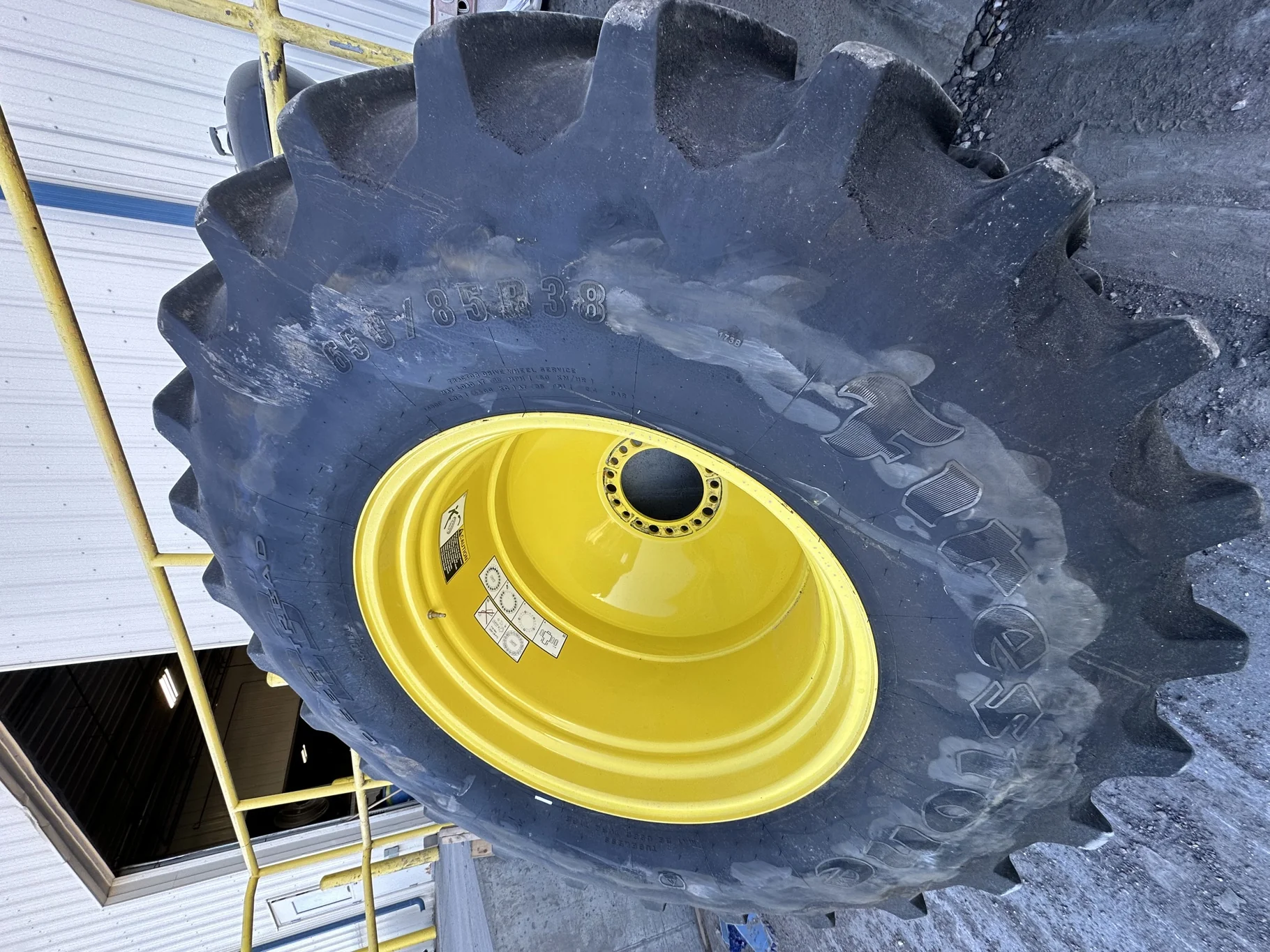 Used 650/85R38 Firestone Radial Deep Tread 23 R-1W 173B TL 85% on a 23 X 38 John Deere Yellow 20 Bol