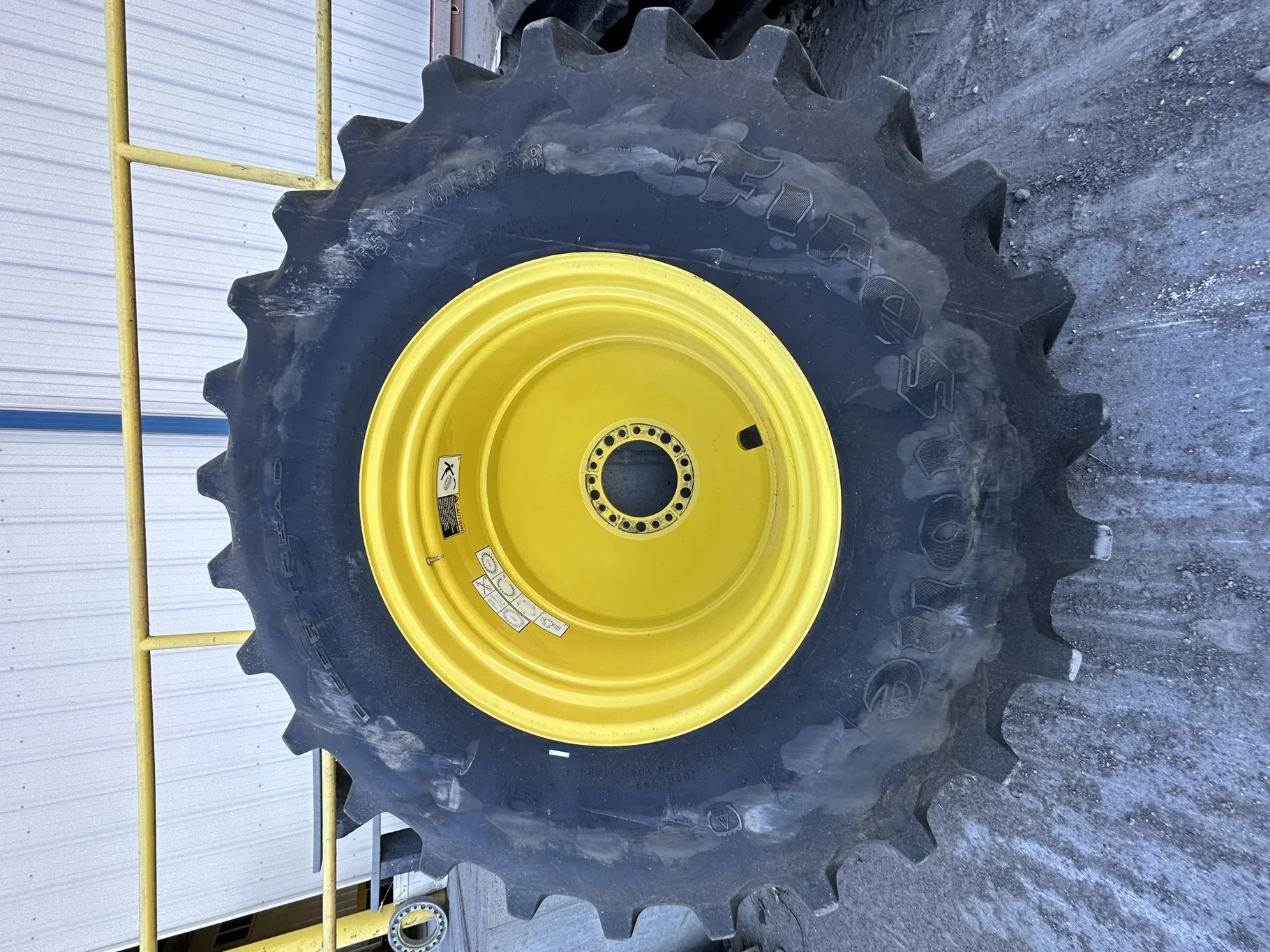 Used 650/85R38 Firestone Radial Deep Tread 23 R-1W 173B TL 85% on a 23 X 38 John Deere Yellow 20 Bol image 2