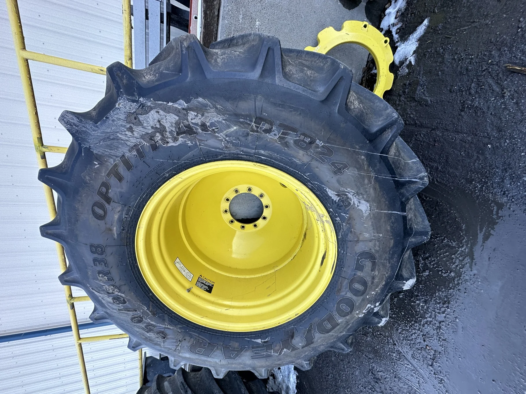 Used 650/85R38 Goodyear Optitrac 173D R-1W TL 90% on a 23 x 38 JD Yellow 10 Bolt Outside Dolly
